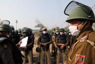 Security personnel wearing protective face masks are seen at the site of a protest against the newly passed farm bills at Singhu border near Delhi