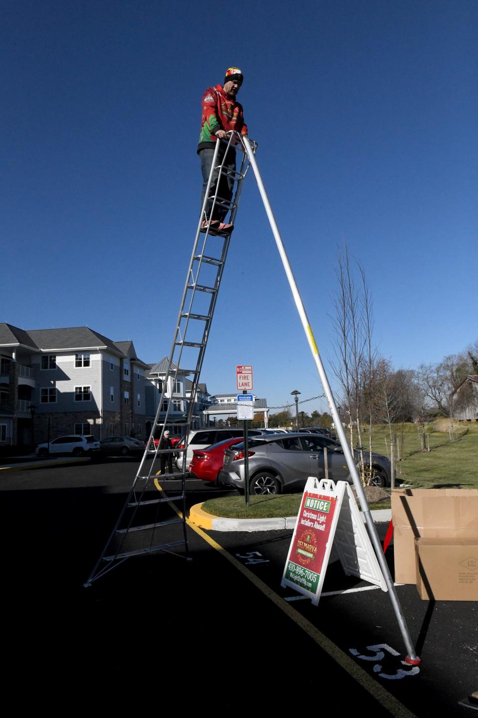 Rob Anderson, owner of Clean Power Wash LLC & Delmarva Christmas Lights, shows one of the ladders that is used to decorate The Lodge at Historic Lewes in Lewes, Delaware.