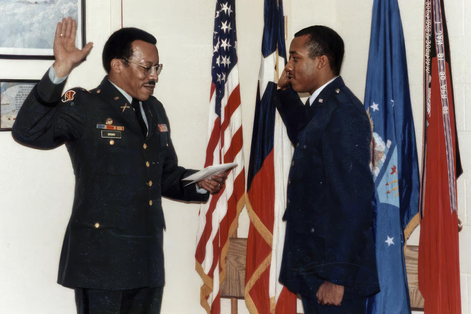 In this image provided by the Brown family, retired Army Col. Charles Q. Brown, Sr., left, administers the commissioning oath of office to Air Force Chief of Staff Gen. CQ Brown, Jr., right, then a cadet at Texas Tech University, in Lubbock, Texas, in May 1984. Brown was commissioned in 1984 as a distinguished graduate of the Reserve Officer Training Corps program at Texas Tech University. (Brown family via AP)