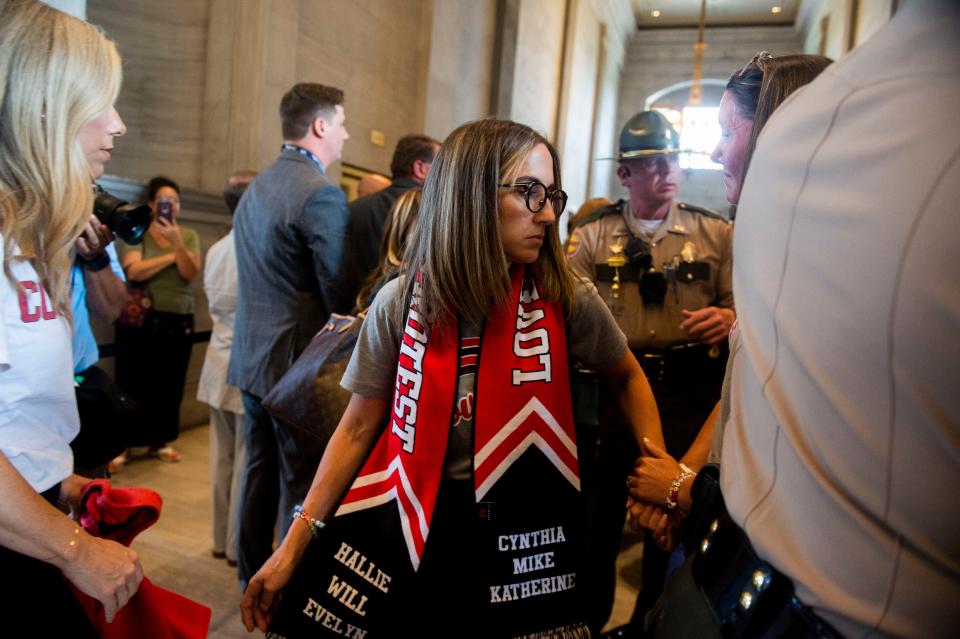 Sarah Shoop Neumann, whose child is a student at the Covenant School and firearm safety advocate leaves the State Capitol Building wearing a scarf in the Covenant school colors and the names of the 6 victims in the 2023 school shooting, in Nashville , Tenn., Tuesday, Aug. 22, 2023.