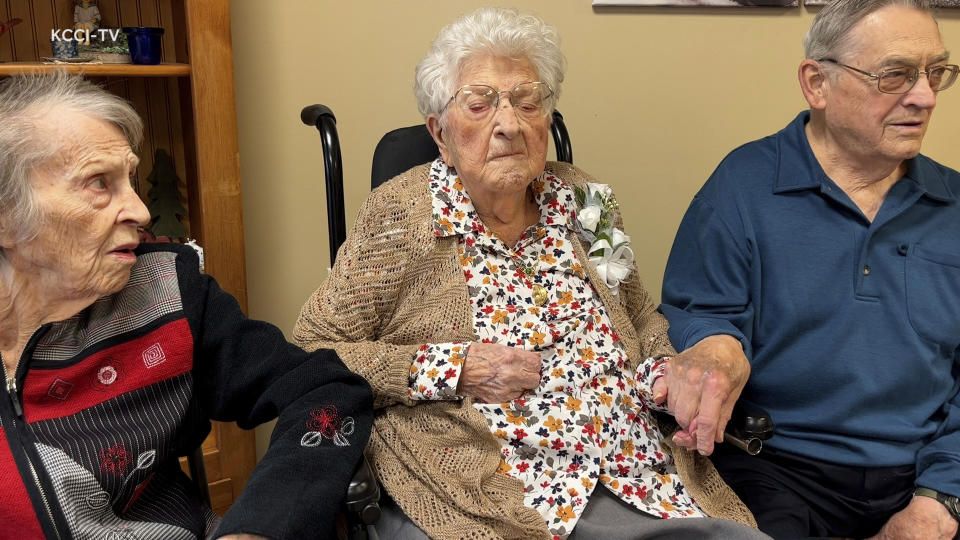 This image made from video, provided by KCCI 8 News in Des Moines, Iowa, shows Bessie Laurena Hendricks, center, celebrating her 115th birthday in November 2022. Hendricks, an Iowa woman who was believed to be the oldest living person in the U.S., died Tuesday, Jan. 3, 2023, at the age of 115. (KCCI 8 News via AP)