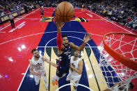 FILE - Philadelphia 76ers' Tobias Harris, center, goes up for a shot between Cleveland Cavaliers' Dean Wade, left, and Georges Niang during the first half of an NBA basketball in-season tournament game, Tuesday, Nov. 21, 2023, in Philadelphia. The NBA has agreed to terms on its new media deal, an 11-year agreement worth $76 billion that assures player salaries will continue rising for the foreseeable future and one that will surely change how some viewers access the game for years to come. (AP Photo/Matt Slocum, File)