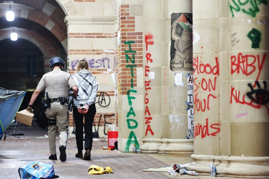 LOS ANGELES, CALIFORNIA – MAY 02: A California Highway Patrol (CHP) officer detains a protestor while clearing a pro-Palestinian encampment after dispersal orders were given at the University of California, Los Angeles (UCLA) campus, on May 2, 2024 in Los Angeles, California. The camp was declared ‘unlawful’ by the university and over 100 protestors who refused to leave were detained during the operation. Pro-Palestinian encampments have sprung up at college campuses around the country with some protestors calling for schools to divest from Israeli interests amid the ongoing war in Gaza. (Photo by Mario Tama/Getty Images)