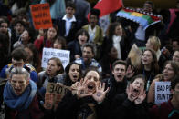 People shout slogans during a march organized by the Fridays for Future international movement of school students outside of the COP25 climate talks congress in Madrid, Spain, Friday, Dec. 13, 2019. The United Nations Secretary-General has warned that failure to tackle global warming could result in economic disaster. (AP Photo/Manu Fernandez)