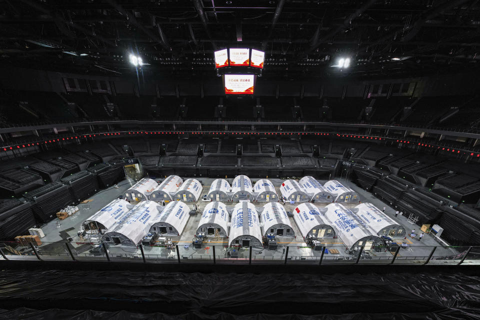 In this photo released by China's Xinhua News Agency, temporary laboratories for nucleic acid testing are seen in a sports stadium in Nanjing in eastern China's Jiangsu Province, Tuesday, July 27, 2021. Drivers seeking to leave eastern China's Jiangsu province will have to show a negative COVID-19 test taken in the last 48 hours or be forced to turn around, as cases in the province continue to rise. (Li Bo/Xinhua via AP)