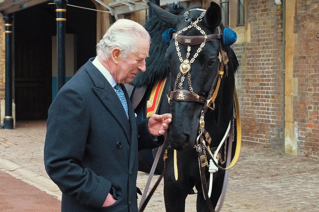 Embargoed until March 11, 2023 - 22:00 GMT / EMBARGOED UNTIL 2200 GMT on March 11, 2023 - An undated handout picture taken and released on March 11, 2023 by Buckingham Palace, shows Britain's King Charles III meeting the black mare 'Noble', a horse gifted to him by the Royal Canadian Mounted Police (RCMP), at the The Royal Mews in Windsor. - The relationship between the RCMP and The Royal Family dates back to 1904, when King Edward VII bestowed the title of Royal on the North-West Mounted Police, making it the Royal North-West Mounted Police. (Photo by BUCKINGHAM PALACE / AFP) / EMBARGOED UNTIL 2200 GMT on March 11, 2023 XGTY / RESTRICTED TO EDITORIAL USE - MANDATORY CREDIT "AFP PHOTO / BUCKINGHAM PALACE / PA WIRE " - NO MARKETING - NO ADVERTISING CAMPAIGNS - NO DIGITAL ALTERATION ALLOWED - DISTRIBUTED AS A SERVICE TO CLIENTS / ADDS EMBARGO EMBARGOED UNTIL 2200 GMT on March 11, 2023 The erroneous mention[s] appearing in the metadata of this photo by - has been modified in AFP systems in the following manner: [---] instead of [---]. Please immediately remove the erroneous mention[s] from all your online services and delete it (them) from your servers. If you have been authorized by AFP to distribute it (them) to third parties, please ensure that the same actions are carried out by them. Failure to promptly comply with these instructions will entail liability on your part for any continued or post notification usage. Therefore we thank you very much for all your attention and prompt action. We are sorry for the inconvenience this notification may cause and remain at your disposal for any further information you may require. (Photo by -/BUCKINGHAM PALACE/AFP via Getty Images)