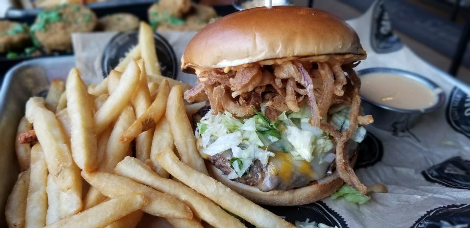 The Griddle Burger with fries at Oak & Stone's downtown Bradenton location photographed May 9, 2023.