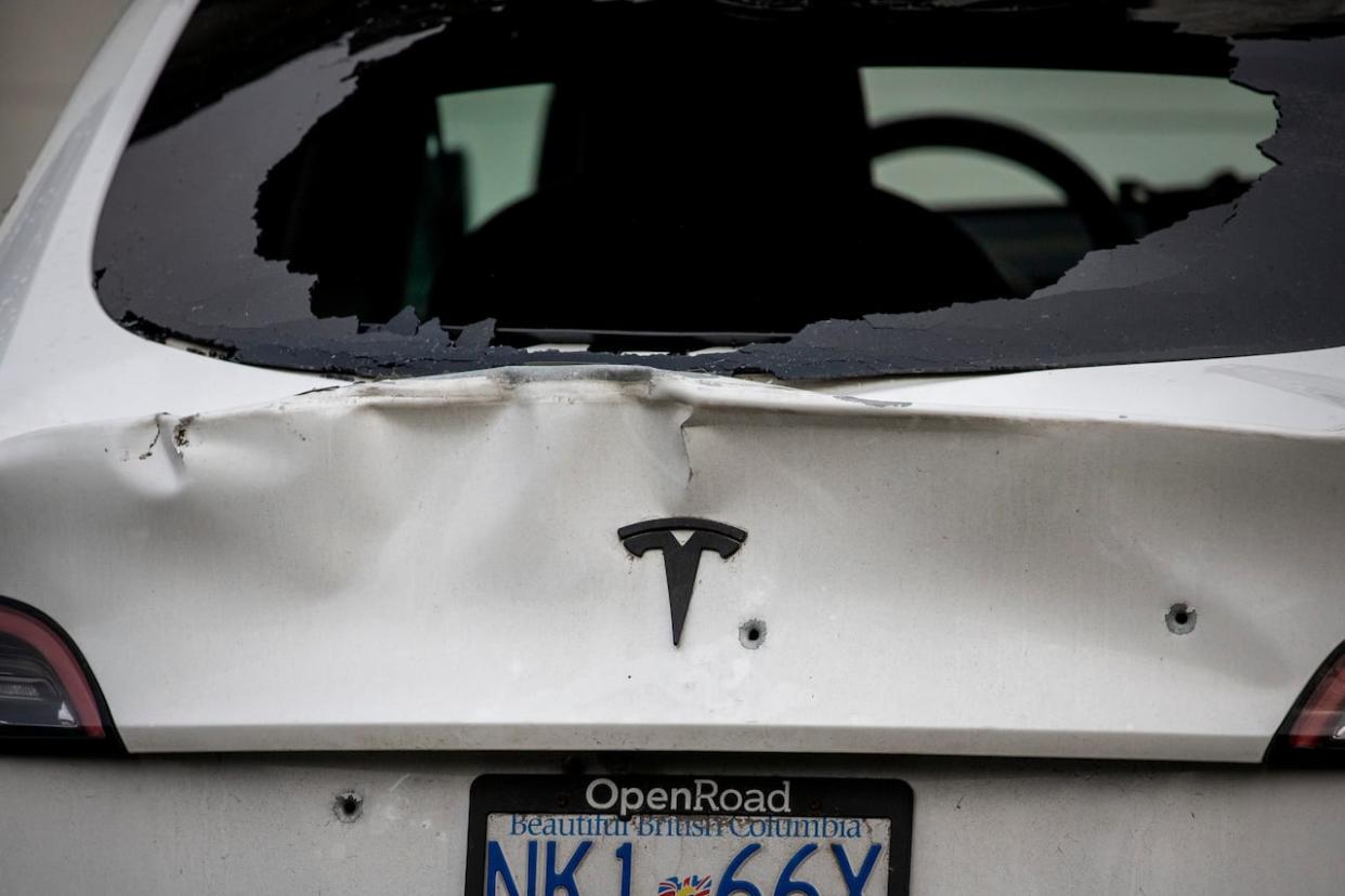 Bullet holes are pictured in a car outside a Surrey residence targeted by gunfire last week. Police say they have arrested two 16-year-olds in relation to the case. (Ben Nelms/CBC - image credit)