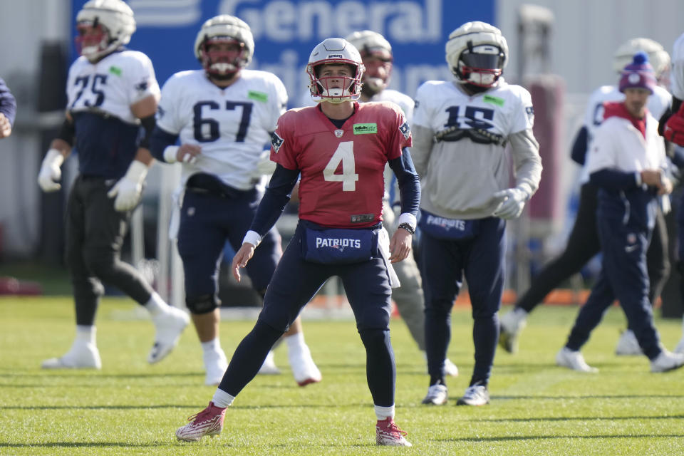 New England Patriots quarterback Bailey Zappe (4) warms up with teammates during an NFL football practice, Wednesday, Nov. 15, 2023, in Foxborough, Mass. (AP Photo/Steven Senne)