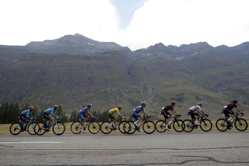 The pack with France's Julian Alaphilippe wearing the overall leader's yellow jersey rides during the nineteenth stage of the Tour de France cycling race over 126,5 kilometers (78,60 miles) with start in Saint Jean De Maurienne and finish in Tignes, France, Friday, July 26, 2019. (AP Photo/Thibault Camus)
