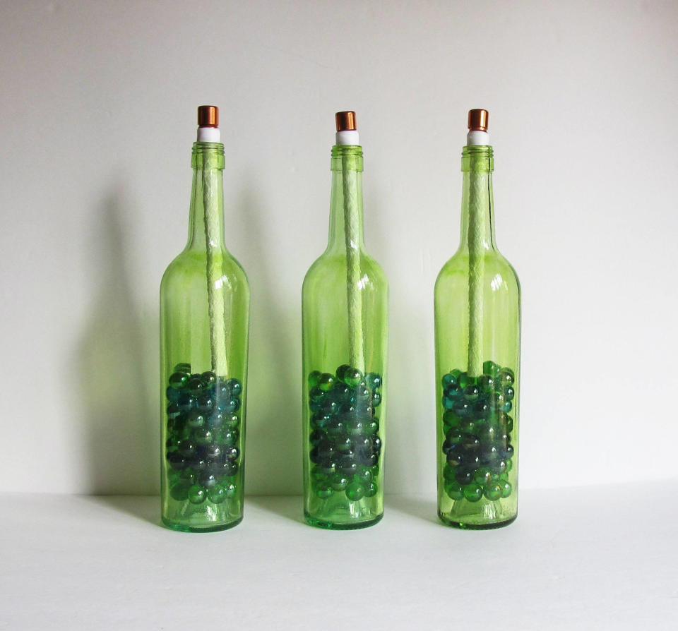 <a href="https://www.etsy.com/listing/527476338/green-wine-bottle-citronella-torches-set?ga_order=most_relevant&amp;ga_search_type=all&amp;ga_view_type=gallery&amp;ga_search_query=green&amp;ref=sr_gallery_25" target="_blank">Shop them here for $42.</a>