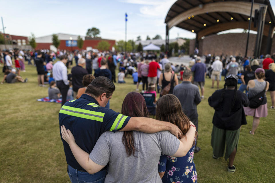 A family embraces during a vigil. (Christian Monterrosa / AFP via Getty Images)