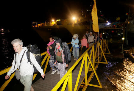 Foreign tourists disembark from a ship after being evacuated from Gili Island following an earthquake on nearby Lombok island, in Benoa Port, Bali, Indonesia August 7, 2018. REUTERS/Johannes P. Christo