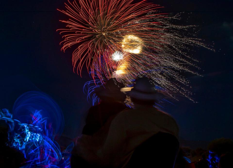 Spectators watch the fireworks display at Fantasy Springs Resort Casino in Indio, Calif., Thursday, June 30, 2022. 