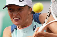 Poland's Iga Swiatek returns the ball to Alison Riske of the U.S. during their second round match of the French Open tennis tournament at the Roland Garros stadium Thursday, May 26, 2022 in Paris. (AP Photo/Michel Euler)