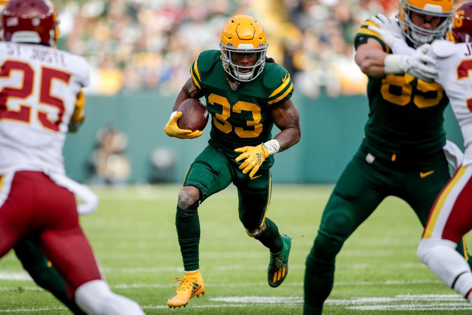 Green Bay Packers' Aaron Jones runs during the first half of an NFL football game against the Washington Football Team on Sunday, Oct. 24, 2021, in Green Bay, Wis.