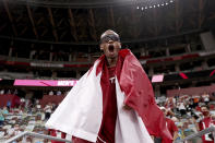 Gold medalist Mutaz Barshim of Qatar celebrates on the track after winning the final of the men's high jump at the 2020 Summer Olympics, Sunday, Aug. 1, 2021, in Tokyo, Japan. (Cameron Spencer/Pool Photo via AP)