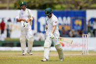 Cricket - Sri Lanka v South Africa - First Test Match - Galle, Sri Lanka - July 14, 2018 - South Africa's Dean Elgar (R) reacts as he walks off the field after his dismissal by Sri Lanka's Dilruwan Perera (not pictured). REUTERS/Dinuka Liyanawatte