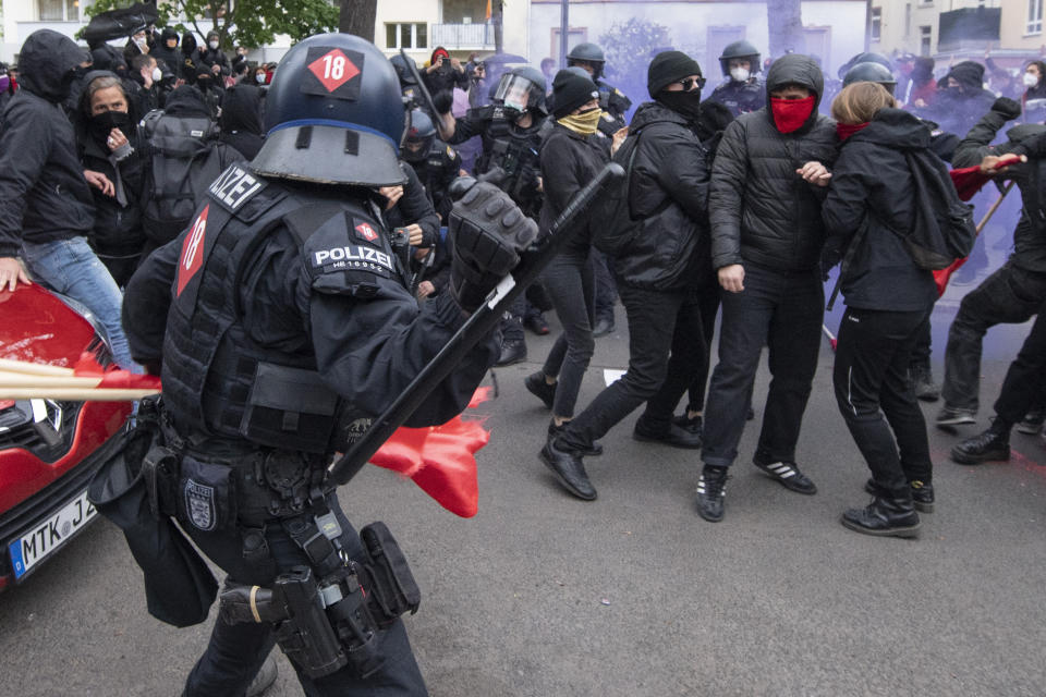 Police and demonstrators clash during the "Revolutionary May Day Demonstration" in Frankfurt Saturday, May 1, 2021. (Boris Roessler/dpa via AP)