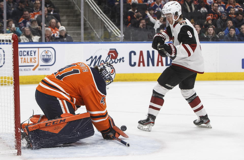 Arizona Coyotes' Clayton Keller (9) is stopped by Edmonton Oilers goalie Mike Smith (41) during third period NHL action in Edmonton, Alberta, on Saturday, Jan. 18, 2020. (Jason Franson/The Canadian Press via AP)