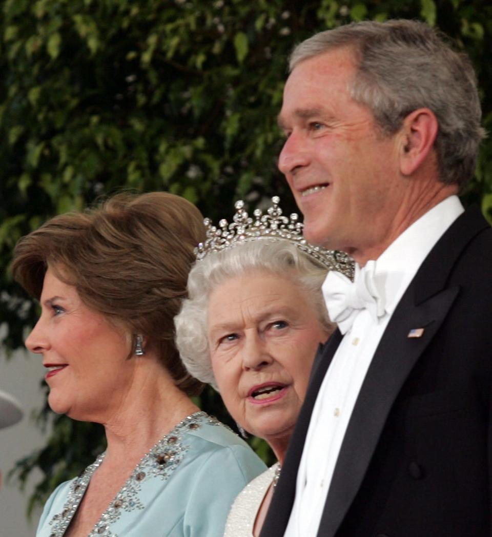 Britain's Queen Elizabeth II stands with US President George W. Bush and US First Lady Laura Bush on the North Portico of the White House upon arrival for a State Dinner on May 7, 2006, in Washington, DC, the first white-tie and tails event of the six-year Bush presidency.