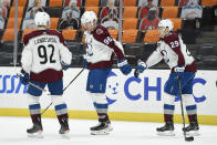 Colorado Avalanche left wing Mikko Rantanen, center, celebrates his empty-net goal with right wing Nathan MacKinnon and left wing Gabriel Landeskog, left, during the third period of the team's NHL hockey game against the Anaheim Ducks in Anaheim, Calif., Friday, April 9, 2021. The Avalanche won 2-0. (AP Photo/Kelvin Kuo)