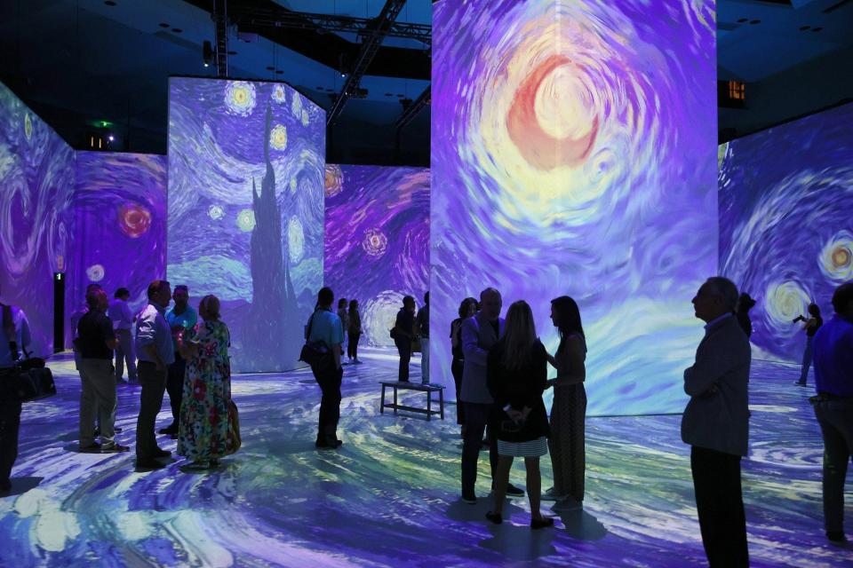 Patrons peruse as Vincent Van Gogh's, arguably most recognized piece, "The Starry Night," appears at Beyond Van Gogh: The Immersive Experience in downtown Jacksonville.