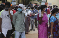 People wait in a queue to give their nasal swab samples to test for the coronavirus at Government Fever Hospital in Hyderabad, India, Wednesday, July 15, 2020. As India’s coronavirus caseload approaches 1 million, lockdowns are being reimposed in parts of the country as governments try to shield the health system from being overwhelmed. (AP Photo/Mahesh Kumar A.)