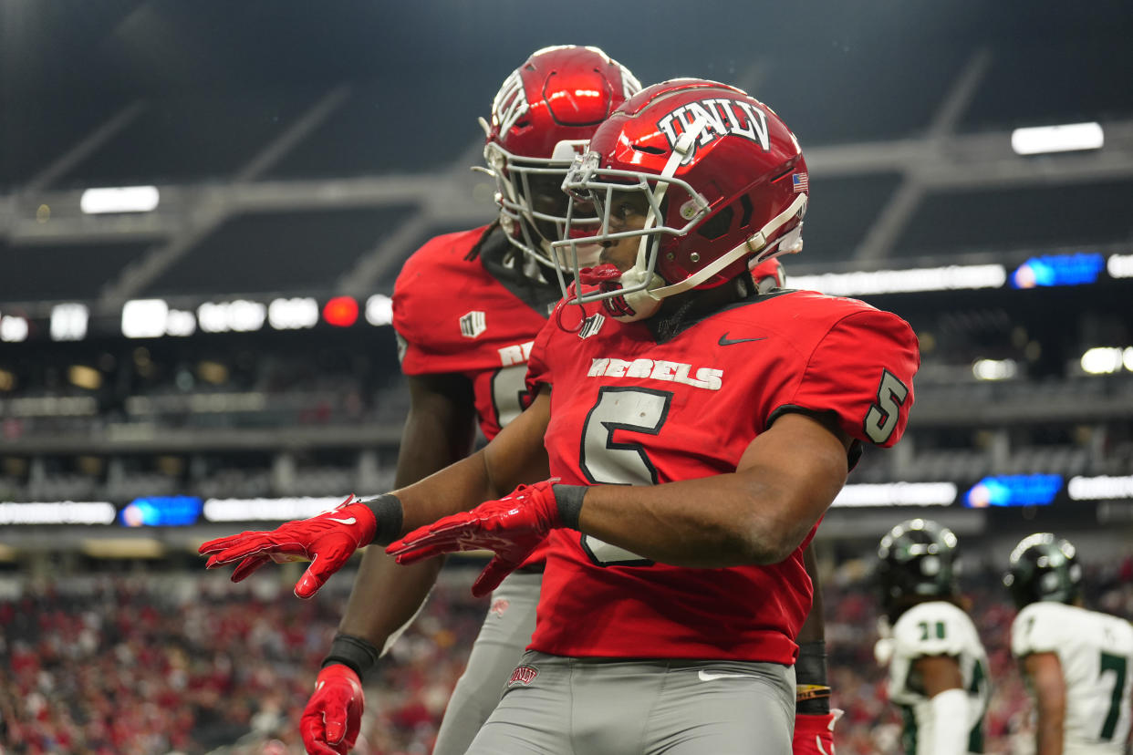 LAS VEGAS, NEVADA - SEPTEMBER 30: Vincent Davis Jr. #5 of the UNLV Rebels celebrates his touchdown with teammates in the second half of a game against the Hawaii Warriors at Allegiant Stadium on September 30, 2023 in Las Vegas, Nevada. Rebels defeat the Warriors 44-20. (Photo by Louis Grasse/Getty Images)