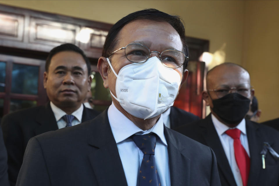 Cambodia National Rescue Party's President Kem Sokha, center, speaks to journalists before heading to the court in his house in Phnom Penh, Cambodia, Wednesday, Jan. 19, 2022. A treason trial against Cambodia’s opposition leader resumed Wednesday, two years after it was adjourned due to the coronavirus pandemic. Kem Sokha was head of the Cambodia National Rescue Party when he was arrested in September 2017 on the basis of an old video showing him telling a seminar about receiving advice from U.S. pro-democracy groups. If convicted, he could be sentenced to for up to 30 years' imprisonment. (AP Photo/Heng Sinith)