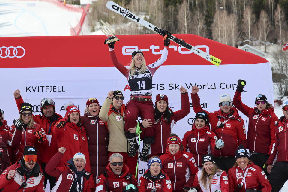 The winner Austria's Cornelia Huetter celebrates with the team after an alpine ski, women's World Cup Super G race in Kvitfjell, Norway, Friday, March 3, 2023. (AP Photo/Marco Trovati)