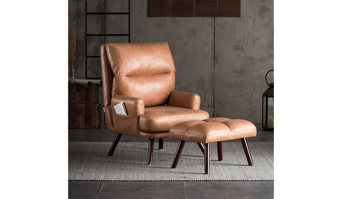 Brown leather armchair and matching foot rest. 