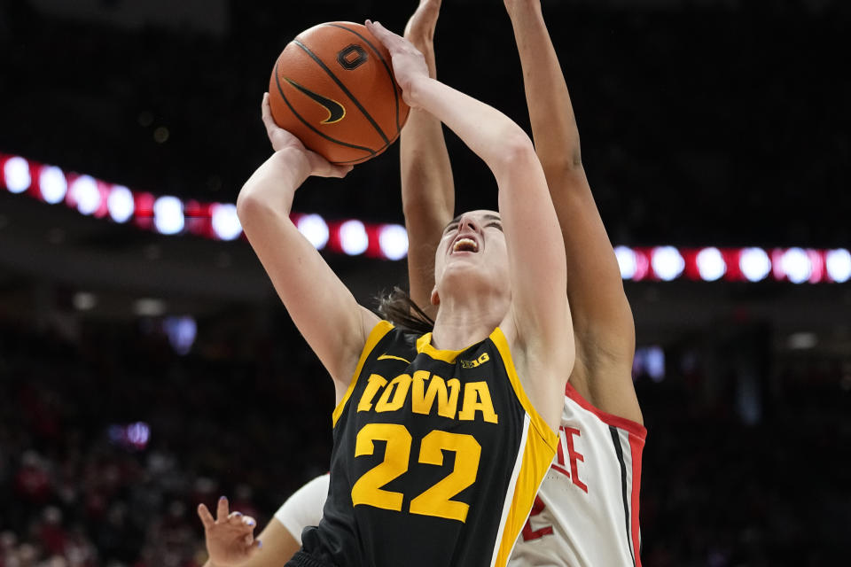 Iowa's Caitlin Clark (22) shoots in front of Ohio State's Taylor Thierry, right, in overtime of an NCAA college basketball game Sunday, Jan. 21, 2024, in Columbus, Ohio. (AP Photo/Sue Ogrocki)