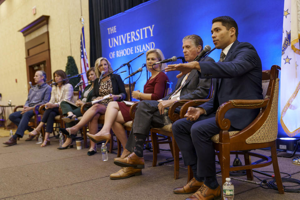 FILE - Democratic challenger for Rhode Island governor, community activist Dr. Luis Daniel Muñoz, right, speaks during a gubernatorial election forum hosted by the Greater Providence Chamber of Commerce in Warwick, R.I., Sept. 8, 2022. From left are Democratic challengers, former Rhode Island Secretary of State Matt Brown, former CVS Health executive Helena Foulkes, Secretary of State Nellie Gorbea, moderator Laurie White, President of the Greater Providence Chamber of Commerce, Republican challenger, businessperson Ashley Kalus, Rhode Island Gov. Dan McKee and Muñoz. (AP Photo/David Goldman, File)