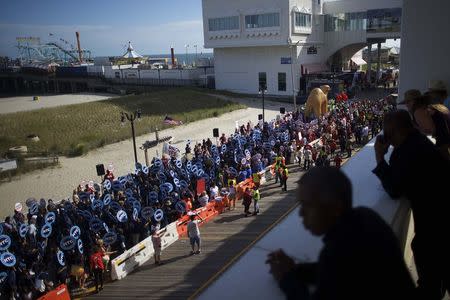 An estimated 2,000 union workers from the mid-Atlantic rally on the boardwalk in front of the Trump Taj Mahal Casino before a march in Atlantic City, New Jersey June 17, 2015. REUTERS/Mark Makela