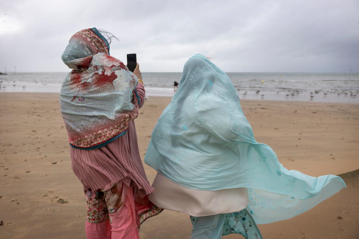 Women battle with strong winds on Margate beach, Wednesday 2 August (Getty Images)