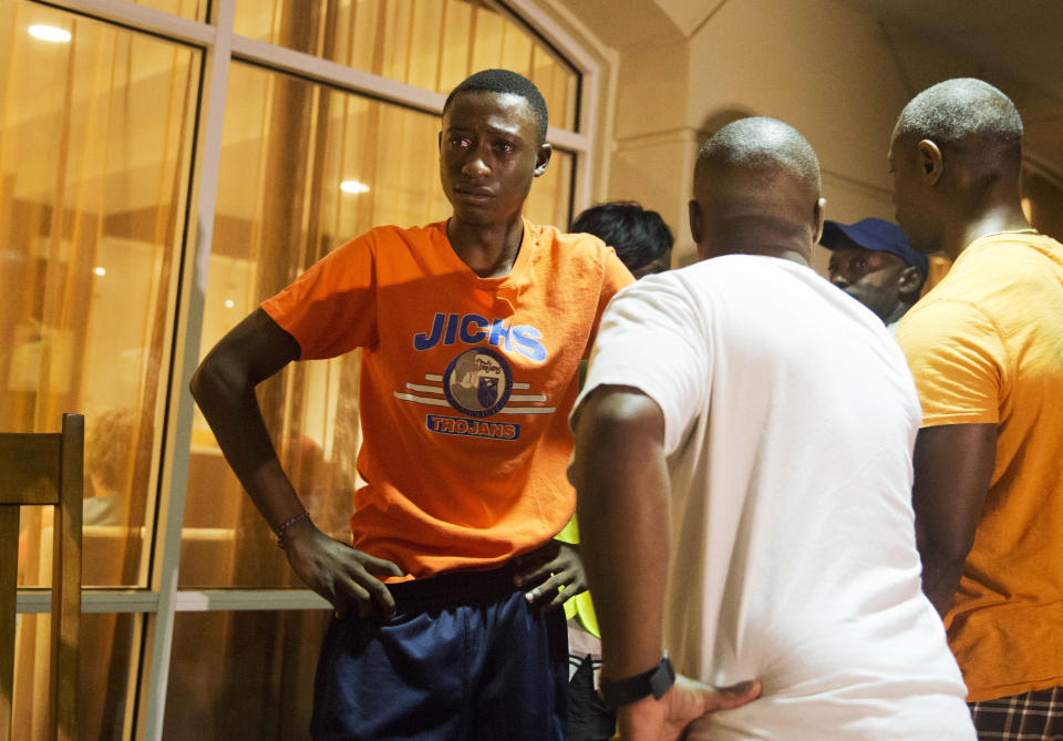 A man looks on as a group of people arrive inquiring about the shooting. (AP Photo/David Goldman)