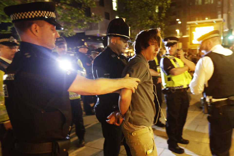 Officers arrests a cyclist after a Critical Mass bike protest outside the Olympic Park during the 2012 Summer Olympics Opening Ceremony, Friday, July 27, 2012, in London. (AP Photo/Matt Rourke)