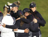 Members of the US team comfort each other after losing to Europe in the Solheim cup at Gleneagles, Auchterarder, Scotland, Sunday, Sept. 15, 2019. (AP Photo/Peter Morrison)