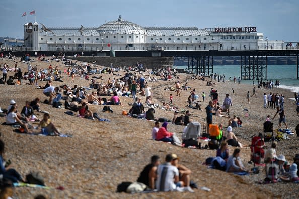 Beachgoers pack the beach in Brighton in the late summer sunshine, on the south coast of England.