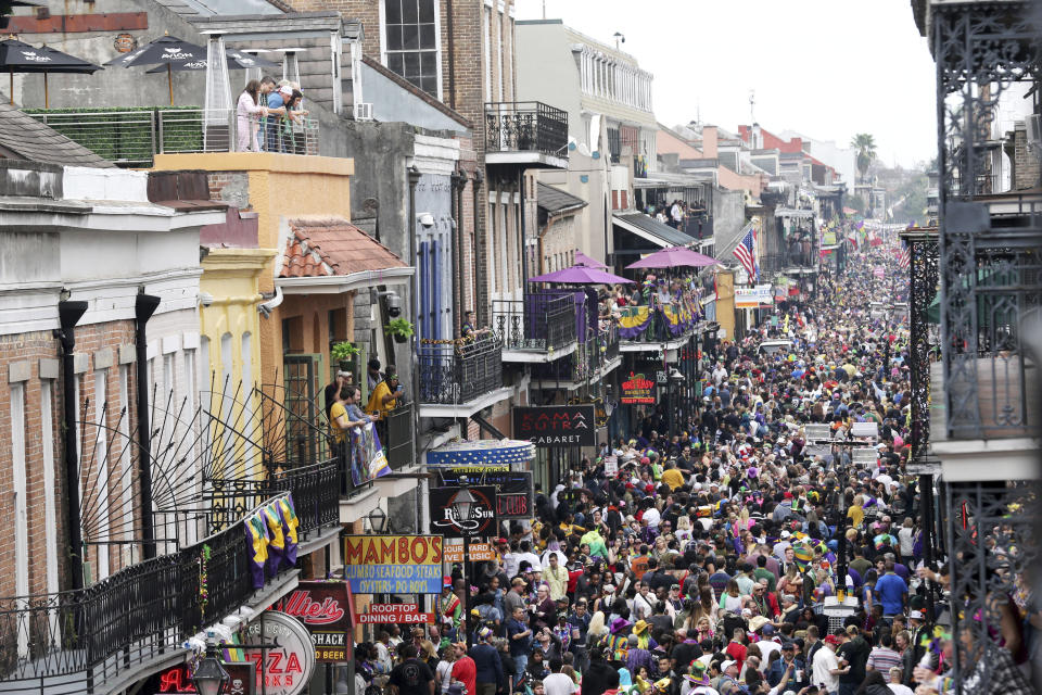 FILE - In this Tuesday, Feb. 25, 2020, file photo, Bourbon Street is a sea of humanity on Mardi Gras day in New Orleans. In the city here, the old saying “Let the good times roll” has given way to a new municipal maxim: “Wash your hands.” A month ago the city was awash in people and steeped in its annual tradition of communal joy — the Mardi Gras season. But now New Orleans has joined those places shutting down bars, eliminating restaurant dining and banning crowds. (AP Photo/Rusty Costanza, File)