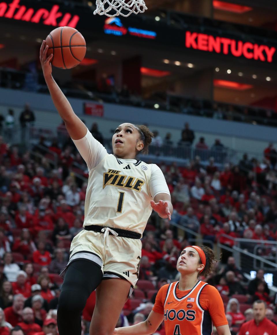 U of L's Sydney Taylor (1) makes a layup against Virginia during a game at the KFC Yum! Center. Feb. 25, 2024