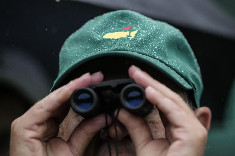 A patron watches on the 12th hole during the weather delayed second round of the Masters golf tournament at Augusta National Golf Club on Saturday, April 8, 2023, in Augusta, Ga. (AP Photo/David J. Phillip)