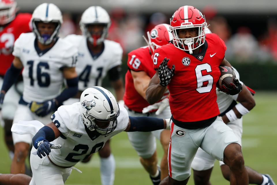 Georgia running back Kenny McIntosh (6) moves the ball down the field during the first half of a NCAA college football game between Samford and Georgia in Athens, Ga., on Saturday, Sept. 10, 2022.