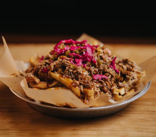 <p>Two Brothers Smoked Meats</p> Pulled pork fries with pickled red onions at Two Brothers Smoked Meats