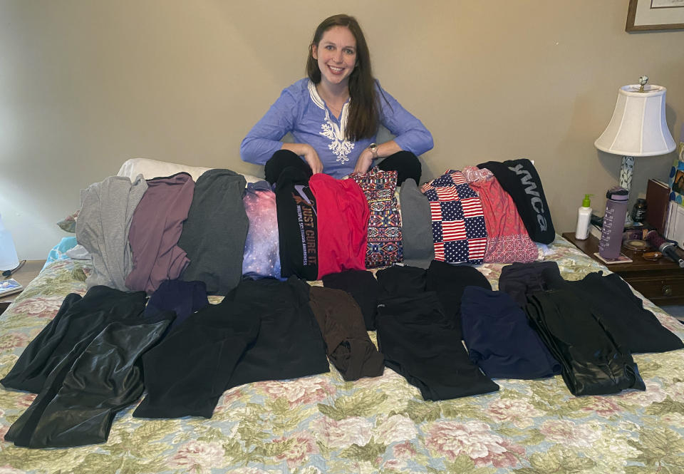 This photo shows Cameron Howe at home in Lynchburg, Va., on June 28, 2021, with her collection of leggings purchased during the pandemic. She hopes to continue wearing leggings as business attire as she transitions back to work, while others are purging their casual pandemic wardrobes. (Cameron Howe via AP)