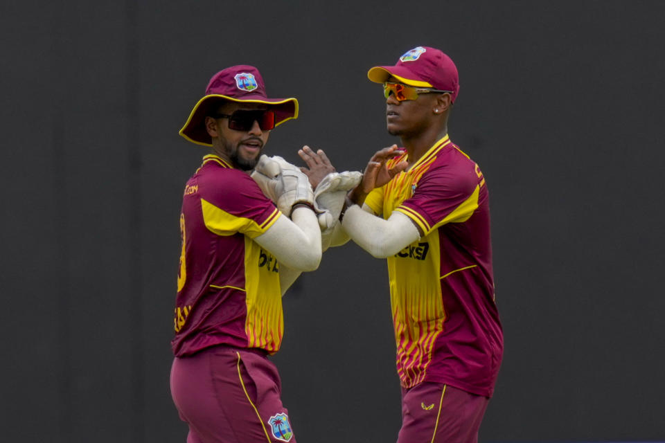 West Indies' Nicholas Pooran, left, celebrates with teammates taking the catch to dismiss India's Axar Patel during their second T20 cricket match at Providence Stadium in Georgetown, Guyana, Sunday, Aug. 6, 2023. (AP Photo/Ramon Espinosa)