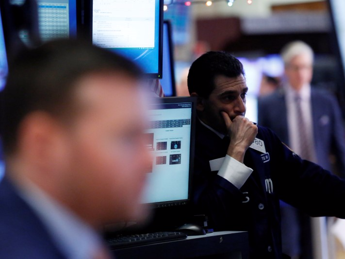 A trader works on the floor at the New York Stock Exchange (NYSE) in Manhattan, New York City, U.S., December 21, 2016. REUTERS/Andrew Kelly 