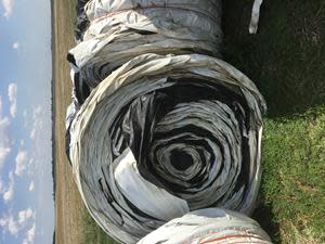 Empty grain bags rolled and ready for recycling at a Cleanfarms collection site.