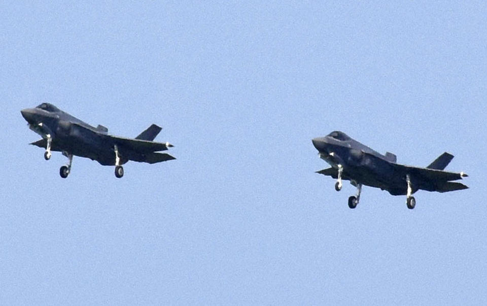 In this Aug. 1, 2019, photo, Japanese Air Self-Defense Force's F-35A stealth fighter jets prepare to land at Misawa Air Base in Misawa, northern Japan. Japan approved Friday, Dec. 20 ,2019, a draft defense budget that included cost to develop own fighter jets to succeed the nation's aging warplanes and import some of F-35 stealth fighters as components for assembly at home rather than importing the expensive American warplanes as finished products to reduce costs and acquire expertise. (Kyodo News via AP)